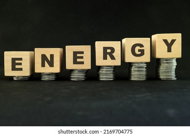 Energy Crisis And High Price Of Fuel, Oil, Gas And And Petrol Concept. Increasing Stack Of Coins In Wooden Blocks With Word Energy On Dark Black Background.