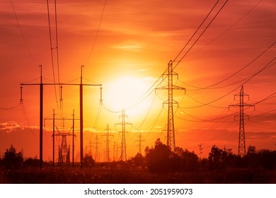 Energy crisis: power lines on a background of sunset in disturbing red tones 