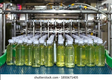 Energy Drink Bottle On The Conveyor Belt In The Production Line Machine Ready For Labeling And Packing At Beverage Manufacturing. Food And Beverage Factory And Industry Concept.