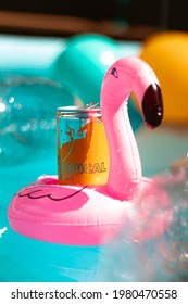 Energy drink on floating floating flamingo on a swimming pool