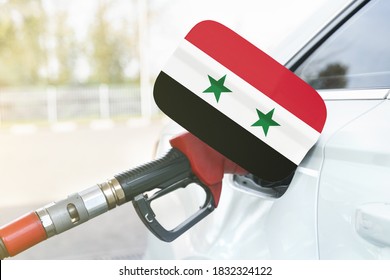 Energy And Economy Concept. Flag Of Syria On The Car's Fuel Filler Flap With Gas Pump Nozzle In The Tank.