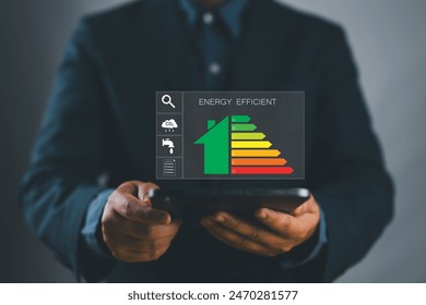 Energy efficiency concept. energy efficient house building rate label audit for sustainable development. Person use smartphone with energy efficiency rating on virtual screen.
 - Powered by Shutterstock