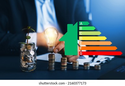 Energy Efficiency Concept With Energy Rating Chart Diagram. Energy Efficiency Rating. Ecological House With Low Consumption On Renovation With Insulation.
