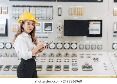 Energy efficiency initiative led by female Asian engineer uses laptop to analyze data and help reduce carbon dioxide emissions and operating costs in power plants and industrial plants. - Powered by Shutterstock