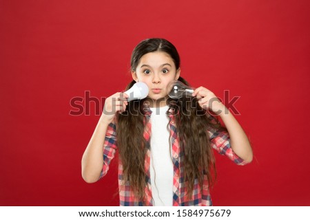 Energy efficient lighting. Ecology problem. Climate change. Eco life. Lighting choice. Little girl light bulbs on red background. Symbol of idea progress and innovation. Environment friendly lighting.