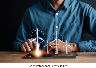 Energy engineer using tablet virtual wind turbine farm with map future, prototype design on holographic projection, Futuristic design with technology application basic, Green energy concept.