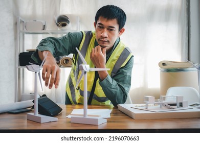 Energy Engineering And Environmental Designer Working With Wind Turbine Model In Green Energy Project And Design For Support Home Electricity Use In The Future.