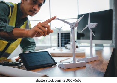 Energy Engineering And Environmental Designer Working With Wind Turbine Model In Green Energy Project And Design For Support Home Electricity Use In The Future.