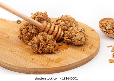 Energy Granola Bites With Honey On A Wooden Plate.