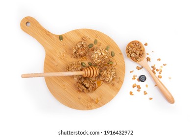 Energy Granola Bites With Honey On A Wooden Plate.