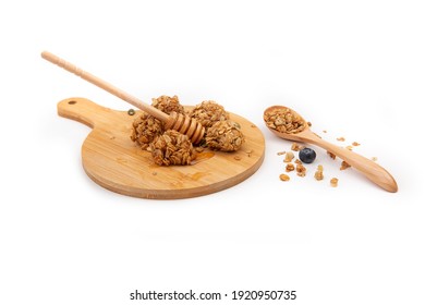 Energy Granola Bites With Honey On A Wooden Plate