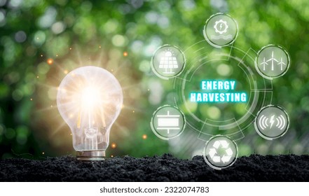 Energy harvesting concept, Light bulb on soil with energy harvesting icon on virtual screen. - Shutterstock ID 2322074783