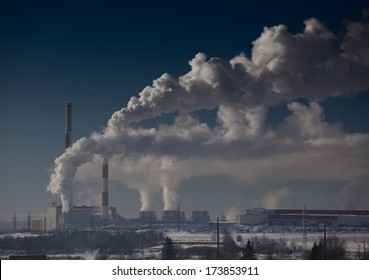 Energy plant with a smoke at sunny day