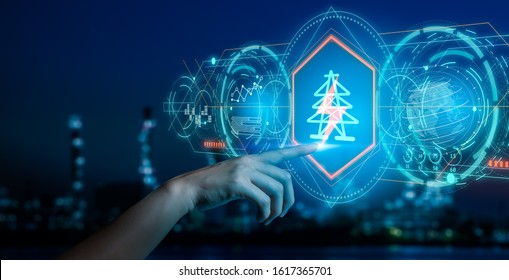 Energy And  Power Plant Concept.Human Hand Holding A Icon Electric Bolt On Blurry Bokeh Power Plant Background.Industry 4.0 Concept Image.