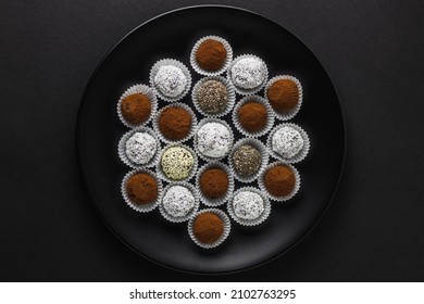 Energy Protein Balls With Healthy Ingredients On Dark Background. Home Made With Dates, Peanut Butter, Flax And Chia Seeds, Oats, Almond And Chocolate Drops