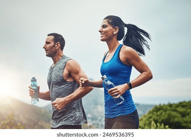 Energy, running and couple for outdoor exercise with water bottle, fitness adventure and training for sport competition. Runner team, man and woman in nature for cardio workout and marathon challenge - Powered by Shutterstock