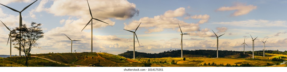 energy saving concept with panorama view from wind turbine construction in field and meadow on mountain with beauty blue sky and cloudy background