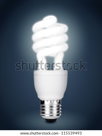 Energy saving fluorescent light bulb isolated on dark background. Clipping path included.