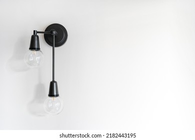 Energy Saving Lamp In Black Metal Sconce On Copy Space Wall. Electricity And Illumination In Living Room. Light Bulb In Modern Loft Style Apartment. Concepts Of Power Equipment And Household Fixture