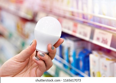 Energy Saving LED Lamp In The Hands Of The Buyer At The Store