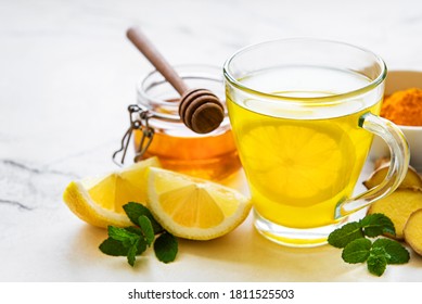 Energy Tonic Drink With Turmeric, Ginger, Lemon And Honey On A White Wooden  Background