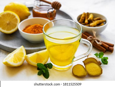 Energy Tonic Drink With Turmeric, Ginger, Lemon And Honey On A White Marble Background