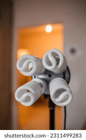 Energy-saving spiral fluorescent lamps in a portable luminaire in construction and decoration - Shutterstock ID 2311499283