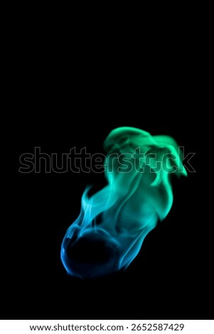 Engage with this captivating visual of vibrant green and blue flames dancing in fluid motion. An enchanting display of light and energy against a black background.
