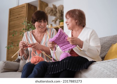 Engaged in heartfelt chatter and the soothing rhythm of knitting. Art of Knitting: Knitting serves as a symbol of creativity, dexterity, and patience in this context.