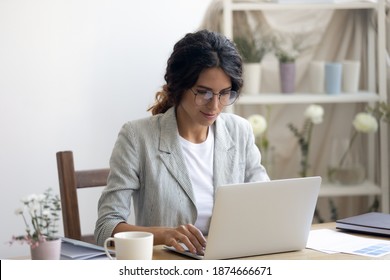 Engaged in work. Happy millennial businesswoman negotiating with client supplier by email messenger. Young lady florist designer using laptop at office studio promoting selling product service online - Shutterstock ID 1874666671