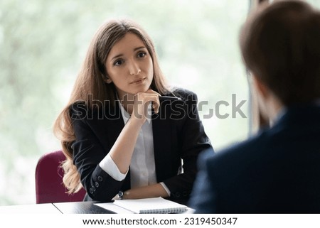 Engaged young recruiter, recruit agent talking to job candidate on interview. Client consulting manager, banker lawyer in office. Business woman, broker, advisor listening to customer on meeting