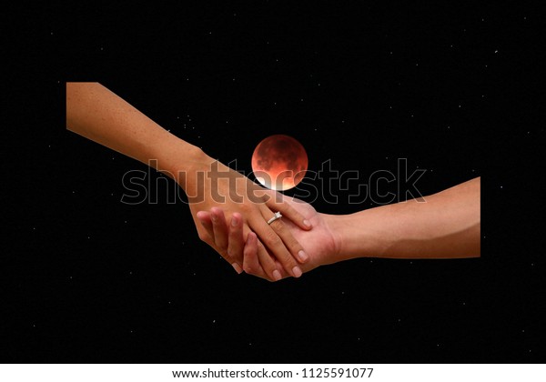Engagement. A couple holds hand with the full\
moon eclipse sky background. Romantic Engagement with wedding right\
and full moon in lunar eclipse.\
\
