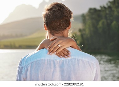 Engagement, hug and couple by lake for romantic holiday, vacation and honeymoon in nature together. Love, proposal mockup and hands of woman holding man for embrace, hugging and affection outdoors - Powered by Shutterstock