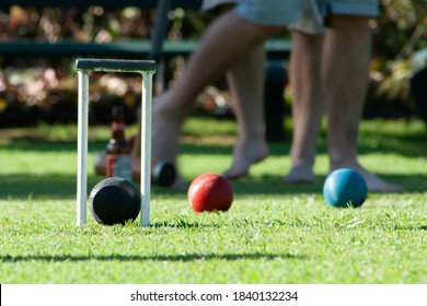 Engagement party playing Croquet on a lazy Sunday afternoon