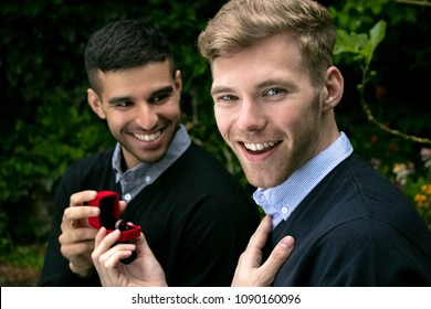 Engagement Proposal Betwen Two Gay Men As One Man Proposes With An Engagement Ring In Red Box