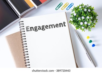 engagement word message on white paper book and copy space on white desk / business concept / top view - Shutterstock ID 389720443