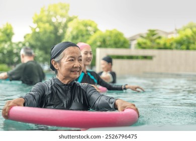 An engaging aquatic exercise class for seniors led by an instructor in a pool. The participants use colorful foam noodles, practicing water-based exercises to stay fit, healthy, and active. - Powered by Shutterstock