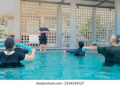 An engaging aquatic exercise class for seniors led by an instructor in a pool. The participants use colorful foam noodles, practicing water-based exercises to stay fit, healthy, and active. - Powered by Shutterstock