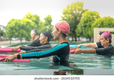 An engaging aquatic exercise class for seniors led by an instructor in a pool. The participants use colorful foam noodles, practicing water-based exercises to stay fit, healthy, and active.