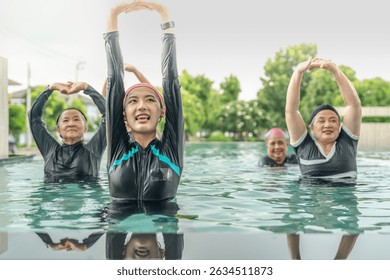 An engaging aquatic exercise class for seniors led by an instructor in a pool. The participants use colorful foam noodles, practicing water-based exercises to stay fit, healthy, and active.