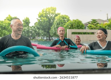 An engaging aquatic exercise class for seniors led by an instructor in a pool. The participants use colorful foam noodles, practicing water-based exercises to stay fit, healthy, and active.