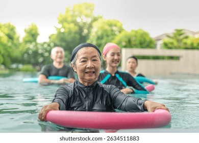 An engaging aquatic exercise class for seniors led by an instructor in a pool. The participants use colorful foam noodles, practicing water-based exercises to stay fit, healthy, and active.