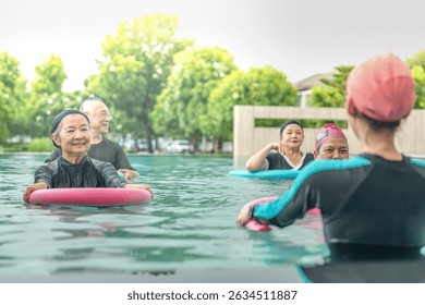 An engaging aquatic exercise class for seniors led by an instructor in a pool. The participants use colorful foam noodles, practicing water-based exercises to stay fit, healthy, and active.