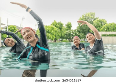 An engaging aquatic exercise class for seniors led by an instructor in a pool. The participants use colorful foam noodles, practicing water-based exercises to stay fit, healthy, and active.