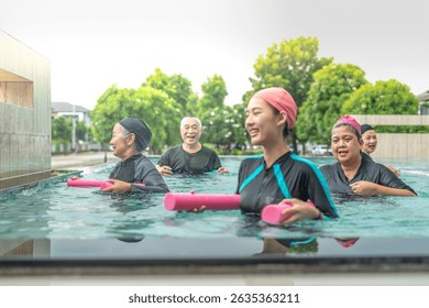 An engaging aquatic exercise class for seniors led by an instructor in a pool. The participants use colorful foam noodles, practicing water-based exercises to stay fit, healthy, and active.