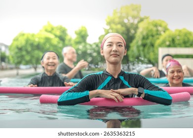 An engaging aquatic exercise class for seniors led by an instructor in a pool. The participants use colorful foam noodles, practicing water-based exercises to stay fit, healthy, and active.