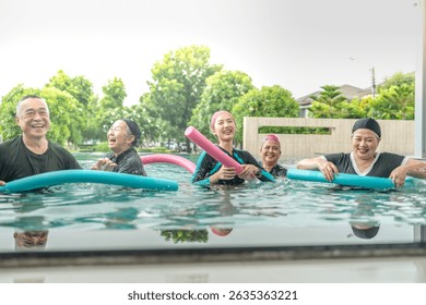 An engaging aquatic exercise class for seniors led by an instructor in a pool. The participants use colorful foam noodles, practicing water-based exercises to stay fit, healthy, and active.