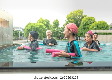 An engaging aquatic exercise class for seniors led by an instructor in a pool. The participants use colorful foam noodles, practicing water-based exercises to stay fit, healthy, and active.