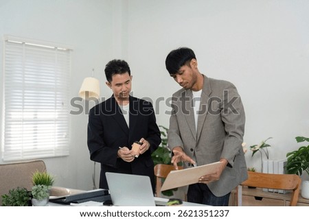 Engaging Business Conversation and Collaboration. Two professionals discussing ideas and strategies in a bright office setting.