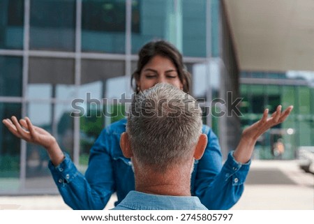 Engaging conversation between two people in front of a modern building during daytime